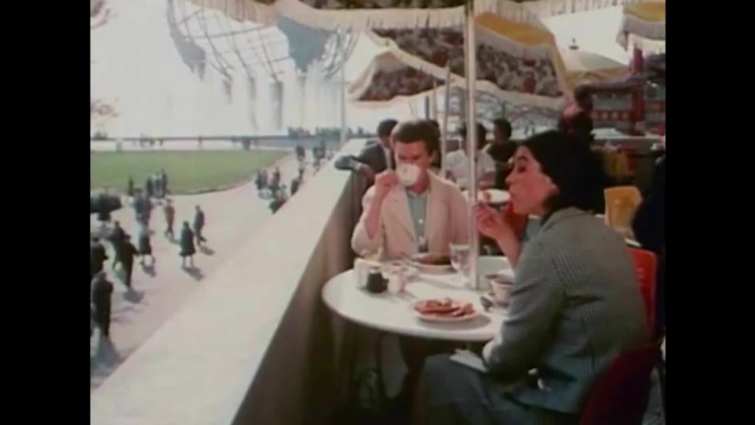 CIRCA 1960s - Two American teachers get lunch at the 1964 New York World's Fair before photographing different international pavilions.