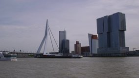 Beautiful Shot Of Rotterdam Skyline with River Boats -- May 2015 Spring -- Of the river Maas at noon day inside the urban city.