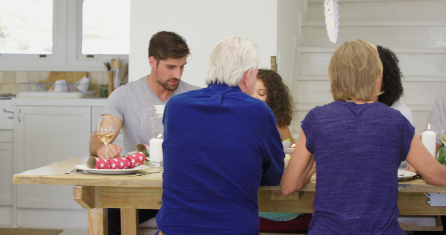 Family with children (4-5, 10-11) sitting at Christmas dinner / Cape Town, South Africa