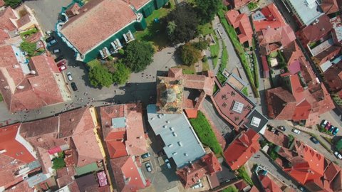 Top down view from drone circling an old ancient church in downtown of Sighisoara in Romania