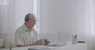 man is working on retirement, consulting client online, staying home, using notebook with internet connection