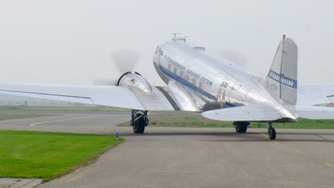 LELYSTAD, THE NETHERLANDS - JULY 7, 2017: Vintage Douglas DC-3 propellor airplane ready for take off at the runway of an airfield.