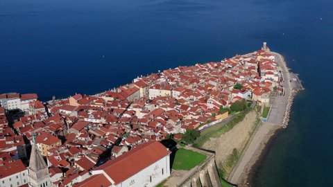 Aerial view of Slovenia's peninsula town of Piran, showing coastlines and historic buildings.