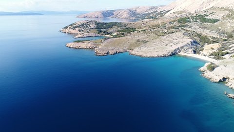 Aerial of deep blue see surrounding Krk island coastline in Baska, Croatia