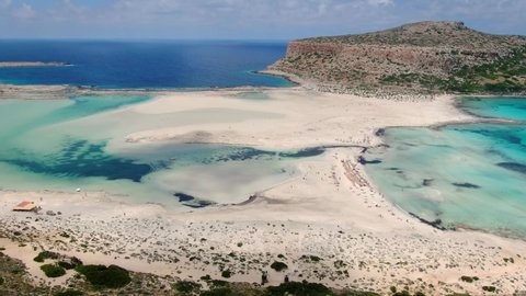 AERIAL. Beautiful white sand beach with turquoise water. Sunny summer day. Paradise. Crete, Greece.