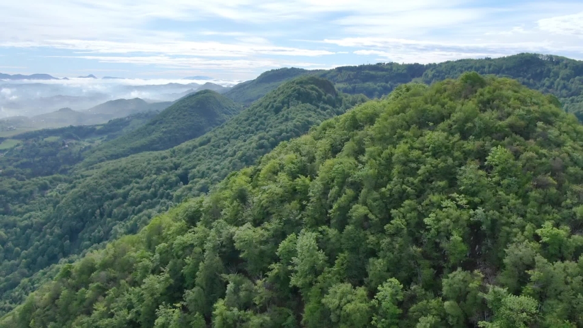 Cinematic aerial shot of an endless mountain and forest landscape in southern Slovenia Royalty-Free Stock Footage #1059788120