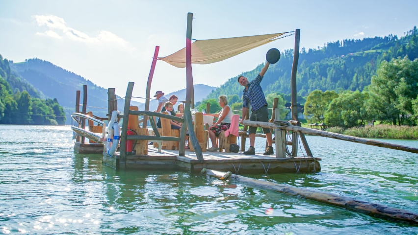 Family Enjoys Relaxing Afternoon Drinking Wine On Raft. Drava River, Muta, Slovenia