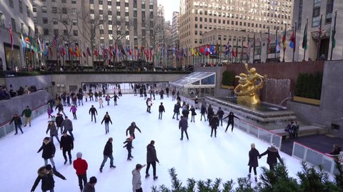 NEW YORK - FEBRUARY, 2020: Ice skating in Rockefeller Center plaza on 5th Avenue. It was built by the Rockefeller family in 1939 and was declared a National Historic Landmark in 1987.
