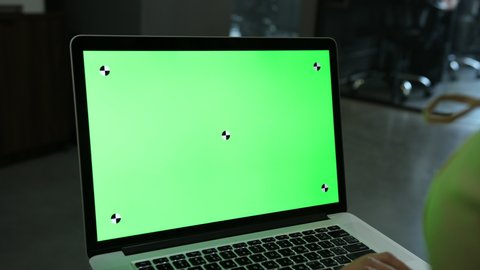 Laptop template with white transparent screen, computer blank display isolated. Metal device. Fingers press keys of the keyboard. Green