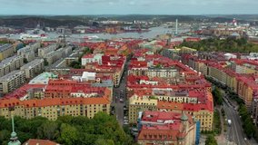 Historical red roof houses in Gothenburg, Sweden. Aerial view by drone moving forward.