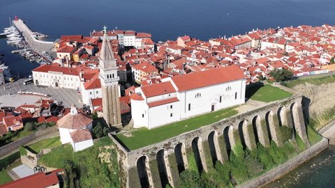 High aerial drone view of parish of Piran and coastal village of red roofs, Slovenia