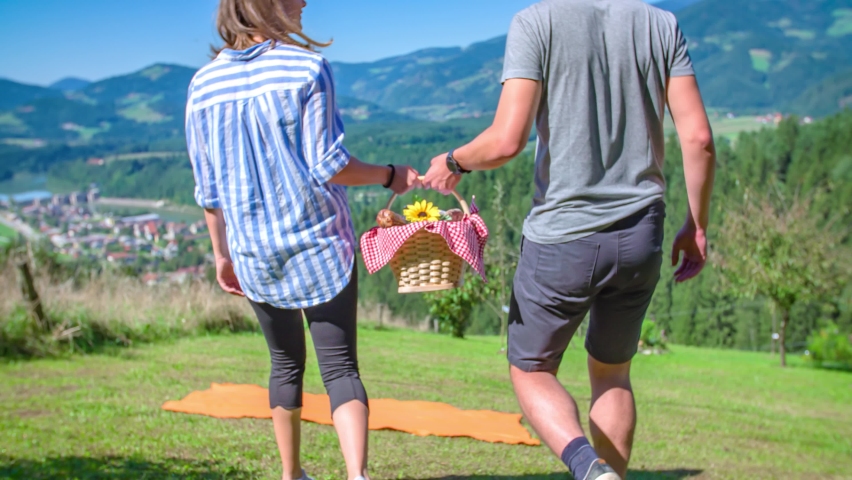 girlfriend and boyfriend walk with a food basket for a romantic picnic