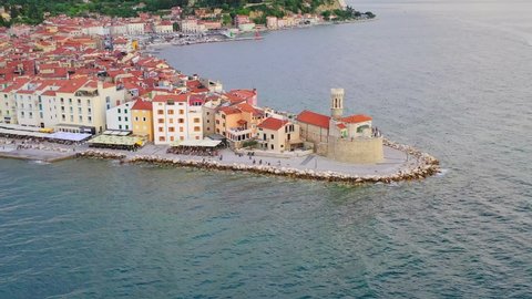 Cinematic view of Piran promenade on a sunny day. Aerial forward