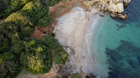 Drone shooting of a paradise beach at sunset near Alghero Sardinia