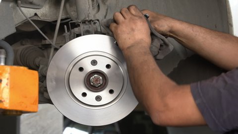 Car Brake Disc And Brake Pads Replacement in the Car Repair Shop.