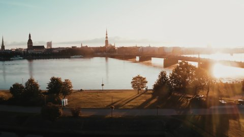 Beautiful sunrise over Riga, Latvia. Flying above river Daugava with Riga old town in the background.
