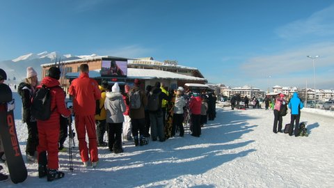 Bansko, Bulgaria - 22 Feb, 2020: Tourist ski people waiting in queue for Ski lift Towards mountain at Bansko ski resort