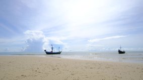 Small fishing boats on shore of thailand, with a beautiful cloud and sunshine backdrop, relaxing color and atmosphere on tropical beach, photo for content or travel banner, 4K UHD, Video Clip