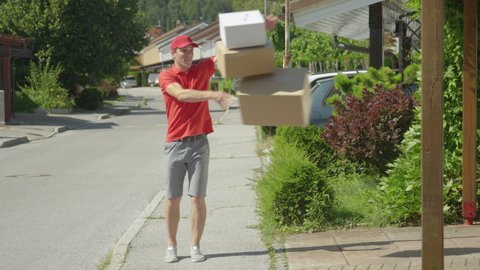 Lazy young delivery guy throws packages in someone's driveway on a sunny day in the suburbs. Careless courier makes his deliveries around the idyllic suburban neighborhood. Horrible delivery service.