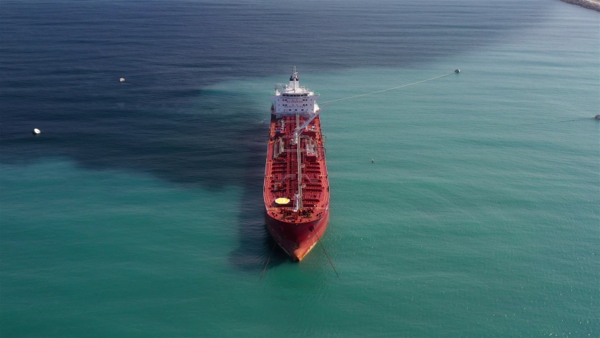 Oil spills out of a ship to Sea- Aerial View
Drone view of oil Chemical Tanker Tied with strings Spills oil in the sea
 | Shutterstock HD Video #1059843653