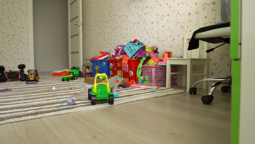 Scattered toys on the floor in the children's room, a mess in the nursery in the absence of children Royalty-Free Stock Footage #1059847202