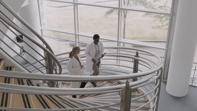 Doctors in hospital on staircase discussing analysis of new corona virus using digital tablet - Powered by Shutterstock - Get 15% off with code: PIKWIZARD15