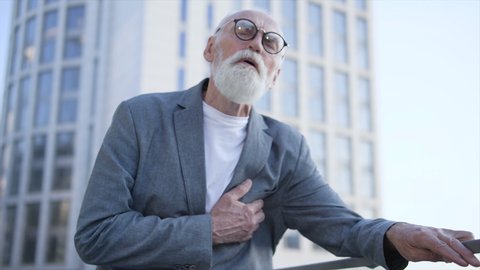 Disappointed man suddenly touching his chest feeling sharp pain, heart attack