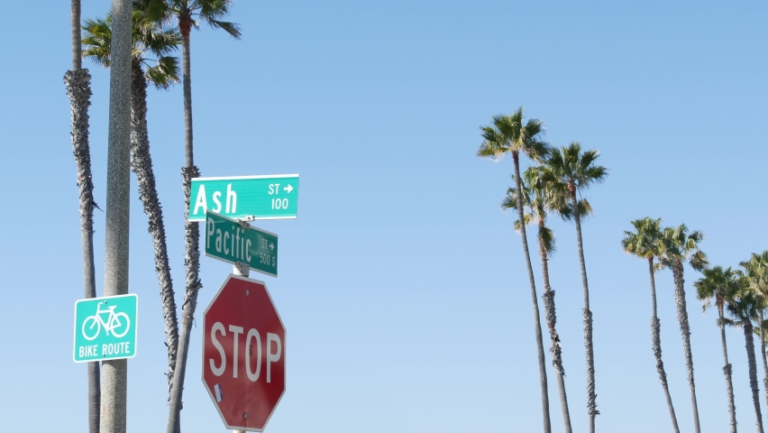 Pacific street road sign on crossroad, route 101 tourist destination, California, USA. Lettering on intersection signpost, symbol of summertime travel and vacations.Signboard in city near Los Angeles.