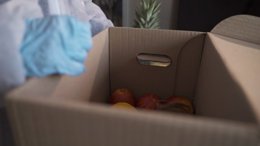 Volunteer in protective suits pack products.