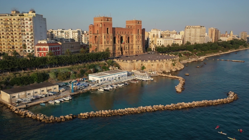 Palazzo del Governo (Governament Palace) in the Center of Taranto, in the South of Italy and the waterfront of the city from panoramic aerial 4K video from flying drone.Taranto, Puglia, Italy (Series)