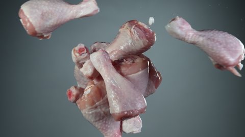 Flying piece of raw chicken legs hitting up in the air. Filmed on high speed cinema camera, 1000 fps.