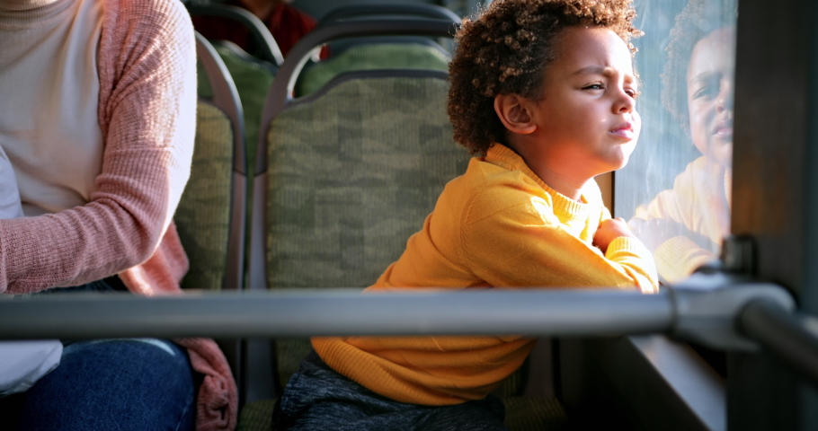 African-american young boy looking out the window inside public bus Royalty-Free Stock Footage #1059857996