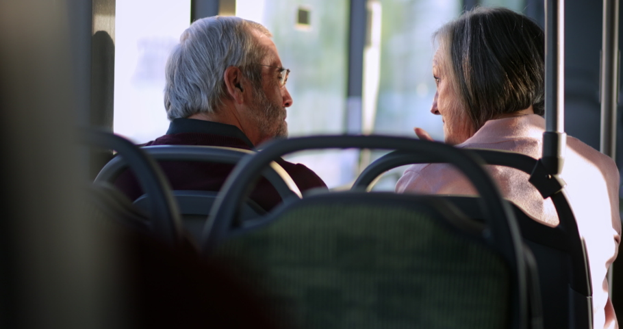 Senior couple talking together traveling inside bus Royalty-Free Stock Footage #1059858056