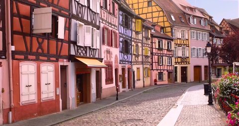 Cobblestone street in Colmar, colourful facades of houses, old town in famous village. Alsace, France