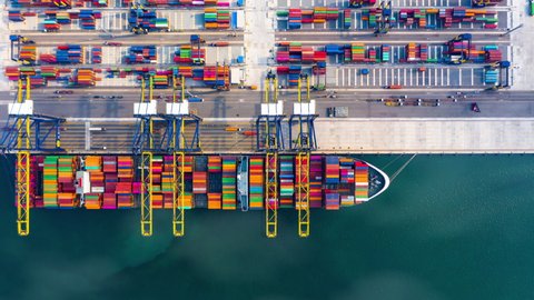 4k footage aerial view timelapse container ship carrying container in import export business logistic and transportation of international by container cargo freight ship at industrial port