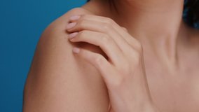 close-up of female arm moisturizing and massaging her shoulder on blue background, relaxation and skin treatment after bath - Powered by Shutterstock - Get 15% off with code: PIKWIZARD15