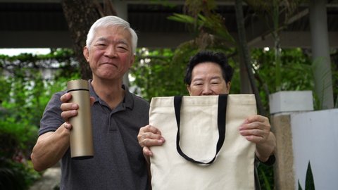 Asian senior elder couple using reusable bag and cup go green to use less plastic lifestyle