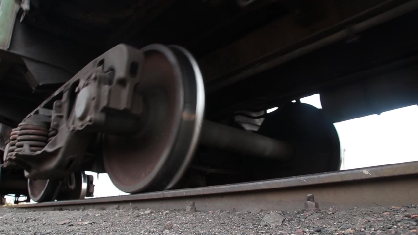 Freight train rides on the railroad. Close up of wheels on Railway. Wheels of a rusty old freight car.