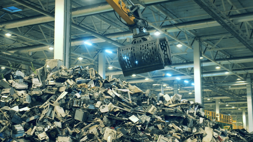 Working machine grabs plastic litter to recycle. Royalty-Free Stock Footage #1059870200