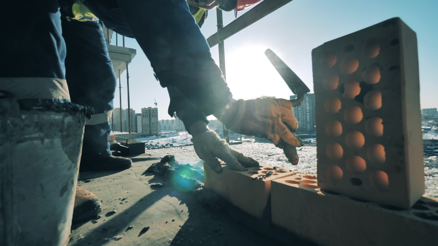 Construction worker is building a wall with bricks and cement Royalty-Free Stock Footage #1059870284