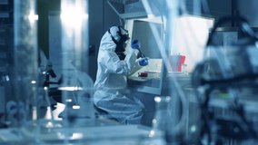 Coronavirus, covid-19, virus research concept. A biologist in suit works in laboratory with coronavirus samples. - Powered by Shutterstock - Get 15% off with code: PIKWIZARD15
