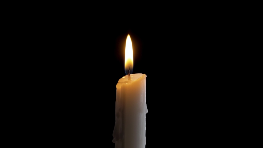A single white candle burning.Isolated candle burning with dark background.White paraffin candle with yellow shades burns on a black background.Background or illustration of remembrance or celebration | Shutterstock HD Video #1059870593