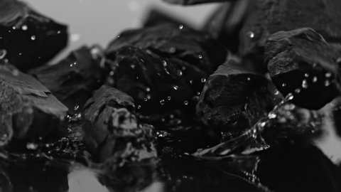 Super Slow Motion Shot of Coal Falling into Water at 1000 fps.
