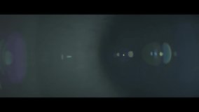 Flickering anamorphic lens flare with radial streaks moving along the side shot on a 152mm parfocal lens from the Lucent Zoom Collection - Lens Flare Video Element - Powered by Shutterstock - Get 15% off with code: PIKWIZARD15
