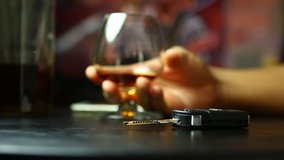 man drinking  whisky  at  bar and  taking car key from table, Don't drink and drive concept. - Powered by Shutterstock - Get 15% off with code: PIKWIZARD15