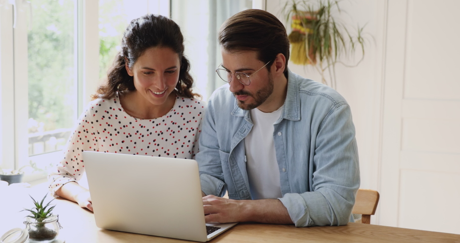 Couple sit at desk indoor check e-mail on computer read great news celebrates success scream with joy feels incredible happy. Bank loan approval letter, victory on-line gambling and lottery concept Royalty-Free Stock Footage #1059881837