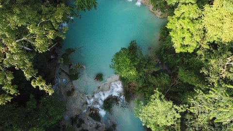 Colorful Exotic Waterfall and Jungle Aerial Scenery, Top Down Birdseye View. Kuang Si Falls, Laos