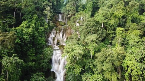 Impressive Kuang Si Cascade Falls in Laos Jungle, Cinematic Aerial. Exotic Waterfall in Rainforest