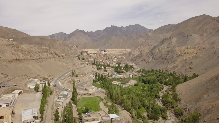 Picturesque Landscape Of Moonland With Lamayuru Monastery And Poplar Trees On Summer - Tibetan Buddhist Monastery In Lamayouro, Leh District, India. - aerial descending