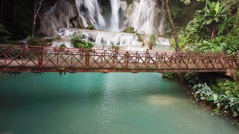 Exotic Heavenly Scene, Static Aerial, Wooden Bridge Under Amazing Waterfall in Laos, Kuang Si Falls